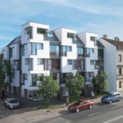 Aussenansicht eines Wohnhauses mit moderner, verschachtelter Fassade.